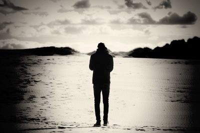Two people standing on beach