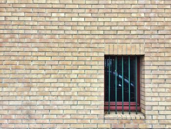 Full frame shot of window on brick wall of building