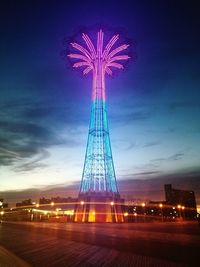 Low angle view of illuminated ferris wheel at night