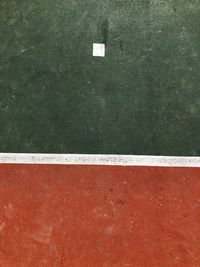 High angle view of arrow sign on wall by swimming pool