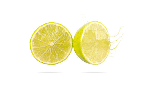 Close-up of lemon slice against white background