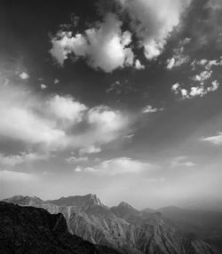 Scenic view of mountains against cloudy sky