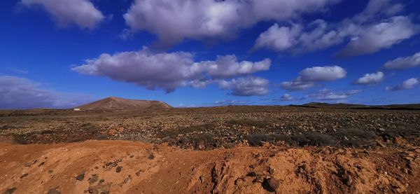 Scenic view of arid landscape against sky