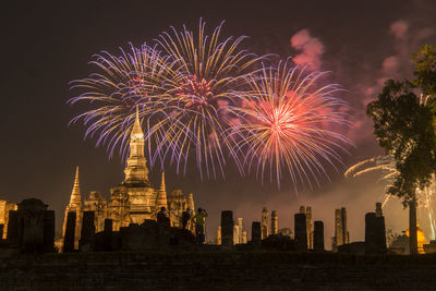 Firework display in city at night