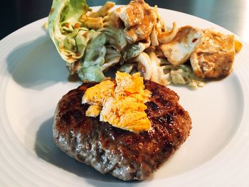 Close-up of burger with salad in plate