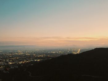 Aerial view of city against sky during sunset