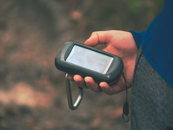Midsection of man using mobile phone