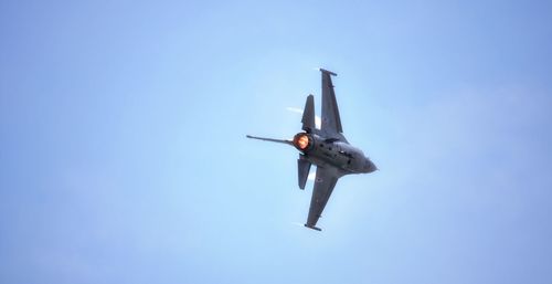 Low angle view of fighter plane flying in clear sky