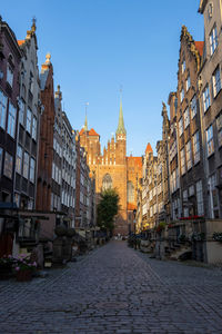 Street amidst buildings against sky in city