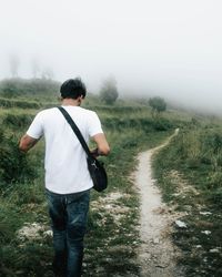 Rear view of man standing on field