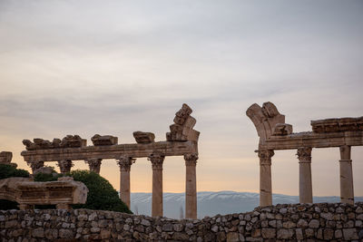 Old ruins of building against cloudy sky