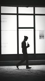 Full length of woman standing on wall