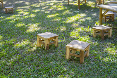 High angle view of empty chairs and table on field