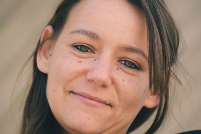 Close-up portrait of smiling young woman