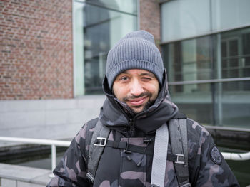 Portrait of man wearing hat standing in winter