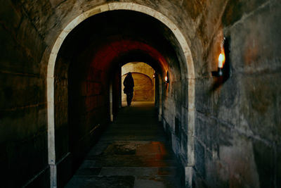 Rear view of man standing in tunnel