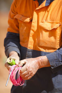 Midsection of man working outdoors