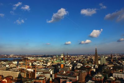 Cityscape against cloudy sky