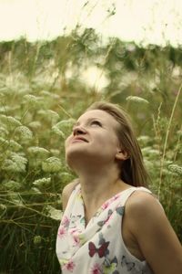 Close-up of young woman with eyes closed standing in grass