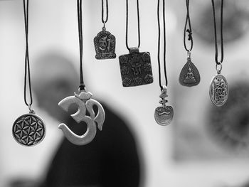 Close-up of various religious necklaces hanging for sale at market