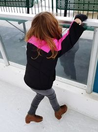 Rear view of girl standing on floor