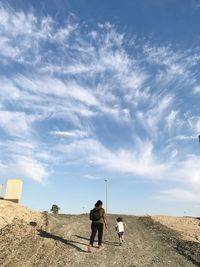 Full length of man standing on road against sky