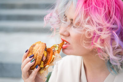 Close-up of woman eating burger