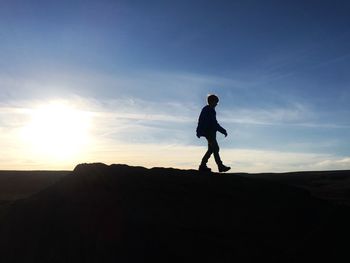 Silhouette of woman at sunset