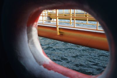 Close-up of sea seen through boat window