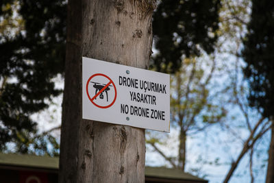 Close-up of a sign with the translation rule no quadcopters, no drone zone