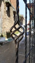 Close-up of metal chain against building