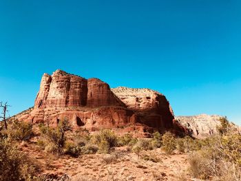 Rock formations on landscape against clear sky