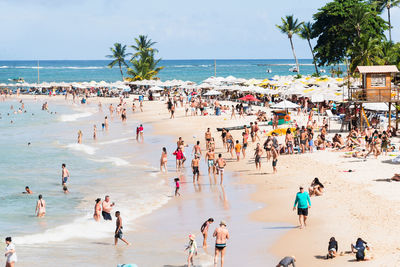 People walking on the sands of morro de sao paulo beach, in the city of cairu.