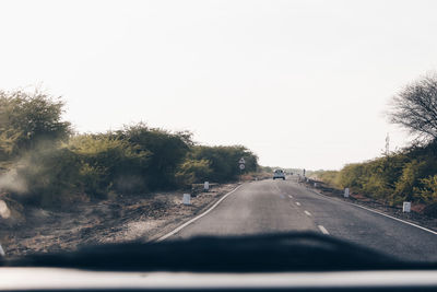 Road seen through car windshield