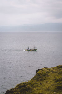 Boat sailing in sea against sky