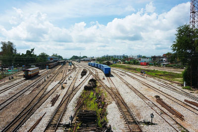 Railroad tracks amidst trees against sky