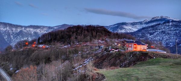Panoramic view of trees and houses against sky during winter