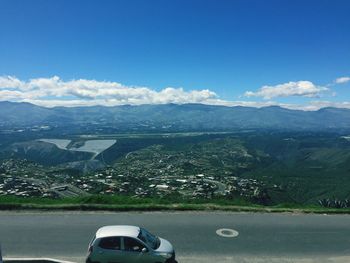 View of landscape with mountain range in background