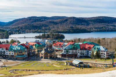 High angle view of townscape by sea against sky