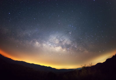 Scenic view of silhouette mountain against sky at night