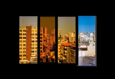 Buildings against sky seen through glass window