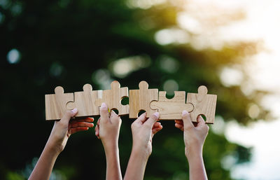 Cropped hand holding jigsaw pieces