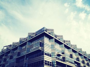 Low angle view of building against cloudy sky
