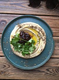 Directly above shot of vegetables and hummus in bowl on table