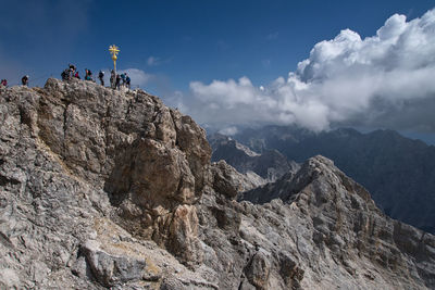 Low angle view of rocks on mountain against sky