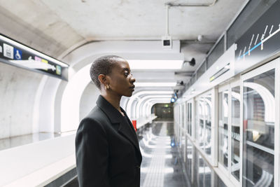 Commuter looking at metro display schedule in subway station