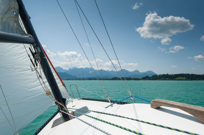 Sailboat sailing on sea against sky