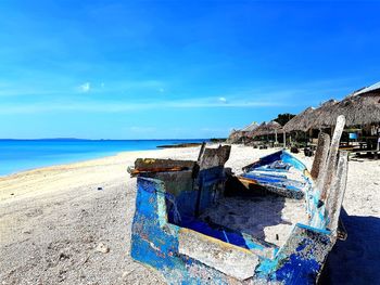 Panoramic shot of sea shore against blue sky