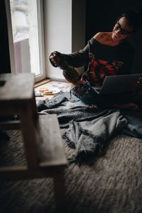 Woman using laptop while siting at home