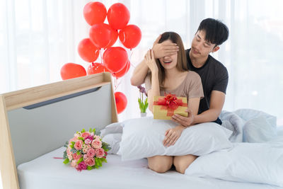 Young couple sitting on table at home